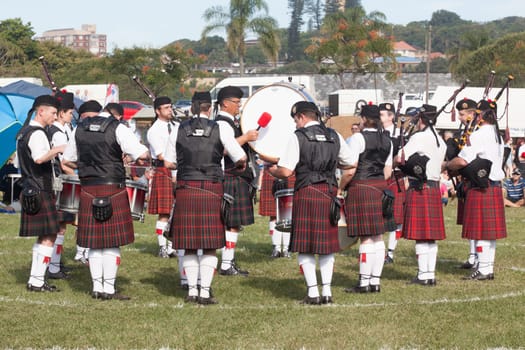 Scottish bands men and women play musical instruments in traditional Scottish clan colors dress at the Scottish Highland Gathering in Toti Durban South Africa