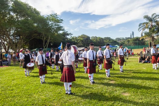 Scottish bands men and women play musical instruments in traditional Scottish clan colors dress at the Scottish Highland Gathering in Toti Durban South Africa