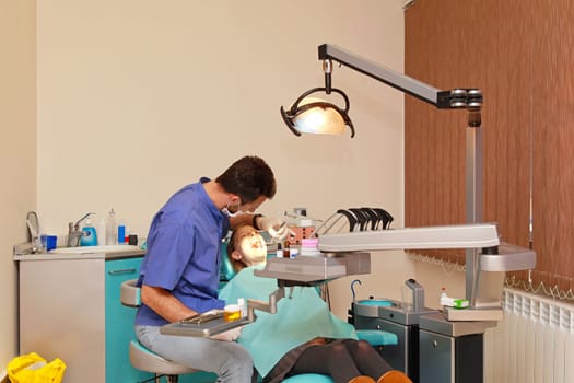Dentist doctor and patient girl in dental clinic