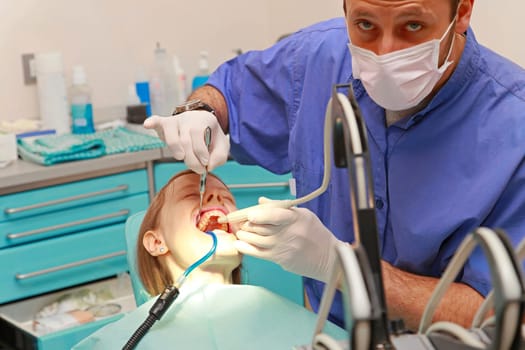 Dentist doctor drilling tooth in dental clinic