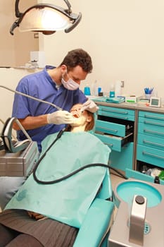 Blonde girl in chair at dentist office