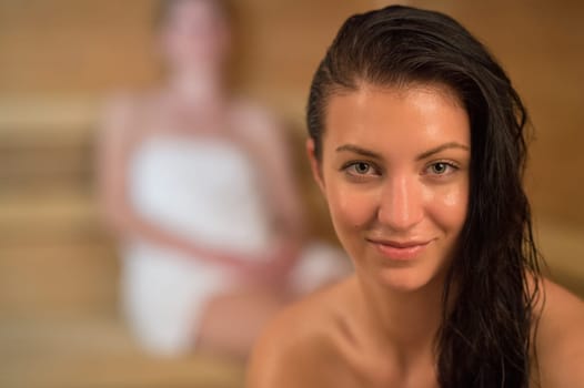 Closeup of smiling sweaty woman in the sauna