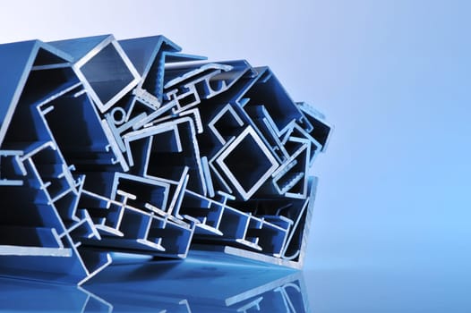 many different aluminium profile strips in blue spotlight