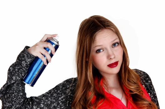 A young woman fixing her hair and putting hairspray on, isolated.for white background..