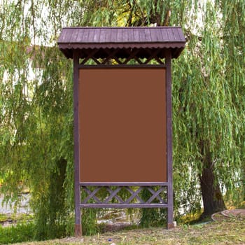 empty billboard in front of green trees