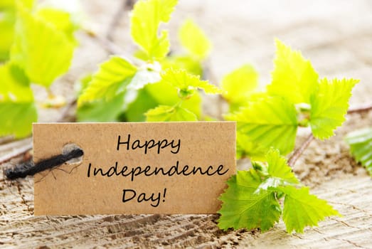a natural looking label with green leaves and wood as background