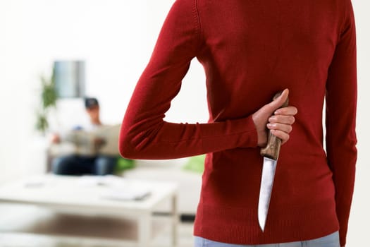 couple conflicts with woman holding knife and looking at husband
