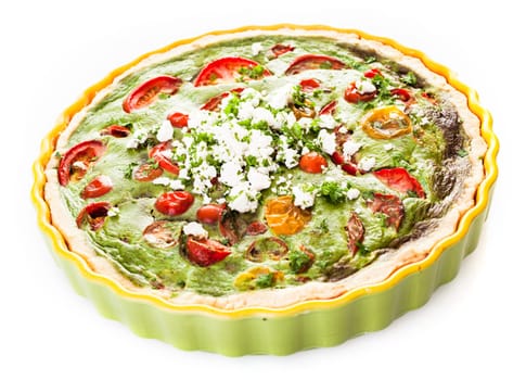 Savory egg tart with tomatoes, herbs and cheese on a golden pastry base served whole in a fluted green pie plate for a healthy delicious vegetarian meal