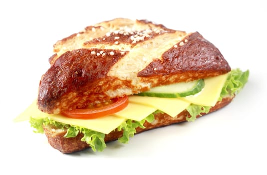 Gouda cheese and salad on a lye bread roll with the traditional crisp brown crust produced by glazing the roll with lye before baking, on white