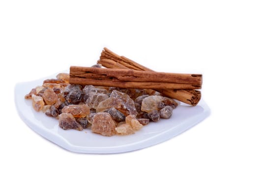 Rock candy sugar and cinnamon on a porcelain saucer