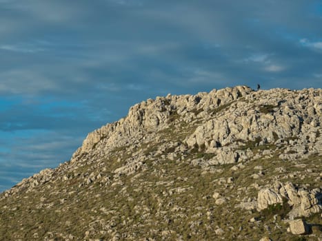 climber in the distance, climbing the hill on the island of Kornat