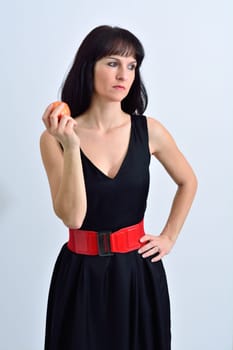 Cute brunette woman with a red apple in the hand