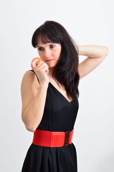 Cute brunette woman with a red apple in the hand