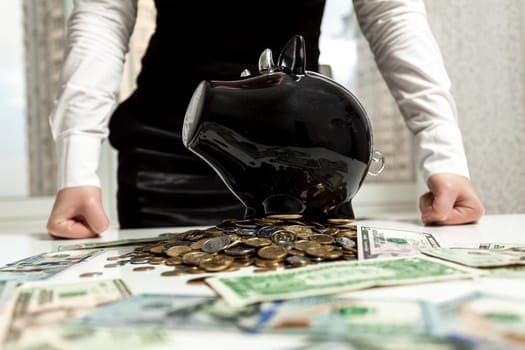Photo of businesswoman standing behind piggy bank on pile of money