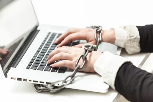Photo of female locked to laptop by chain