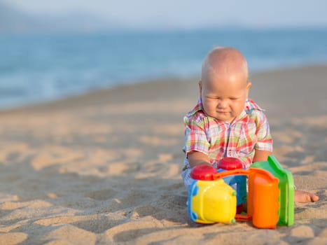 Cute baby is playing toy car