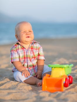 Cute baby is playing toy car