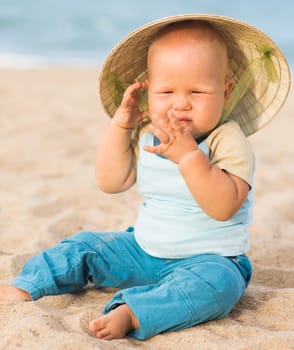 Cute baby on the tropical beach