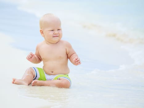 Cute baby on the tropical beach