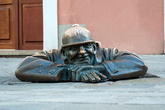 Cumil, emerging statue in the city of Bratislava, Slovakia.