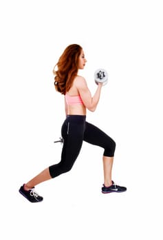A lovely slim women in black exercise pants and sports bra working.out with dumbbell's, isolated on white background..