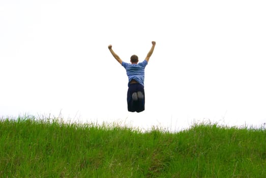 Young guy in jump on background field