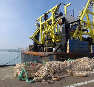 fishing nets in front of a fishing trawler in the scheveningen harbor in the netherlands