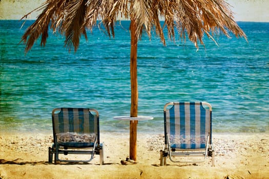 Vintage photo of chairs and umbrellas on the beach