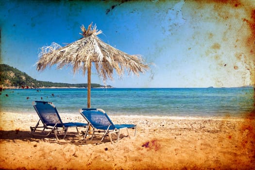 Vintage photo of chairs and umbrellas on the beach