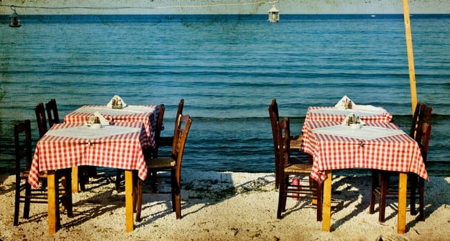 Greek specific - Vintage photo of dining table and chairs set outside on a beach
