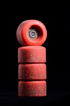 Old Vintage Consumed Skate Wheel on a Black Background