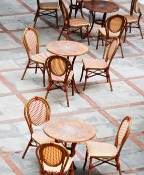 Tables and chairs in a street cafe