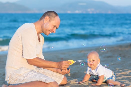 Father and baby are making bubbles