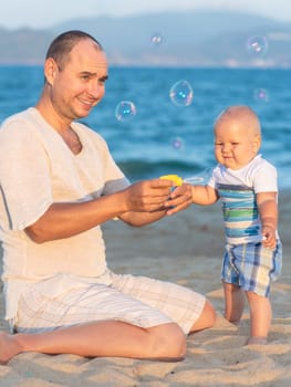 Father and baby are making bubbles