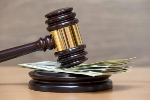 Law gavel on a stack of American money