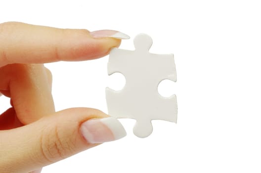 hand holding a puzzle piece