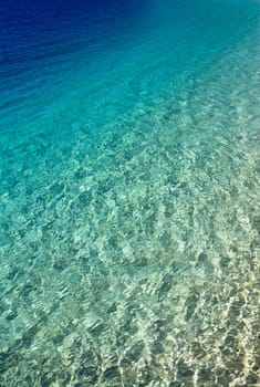 Blue water with sun reflections