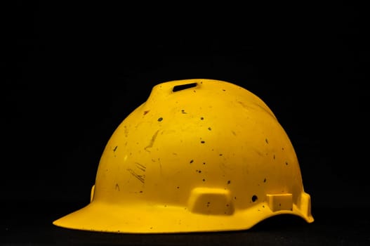 Yellow Safety Helmet on a Black Background