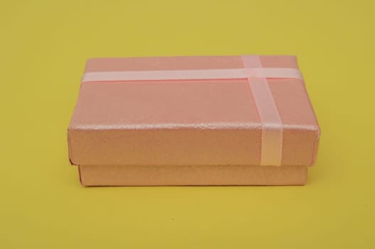 Red gift box with gold bow isolated on white