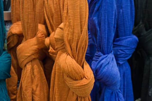 Many bright female scarfs isolated on a fashion shop