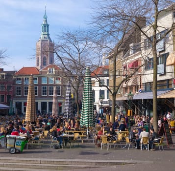 people enjoying the nice weather on terraces in the center of The Hague. The Hague is the third city in the Netherlands with over 500,000 residents