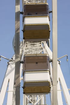 The photograph of gondolas of a Ferris wheel.