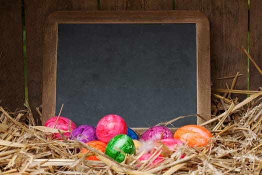 colorful easter eggs with slate board