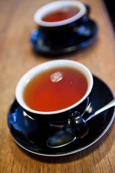 Closeup of two cups of tea on wooden table