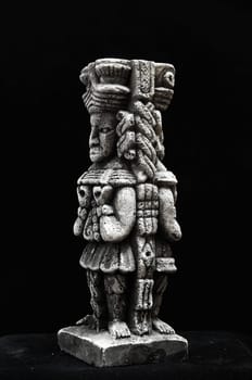 One Ancient Mayan Statue on a Black Background