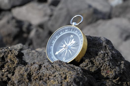 Orientation Concept - Analogic Compass Abandoned on the Rocks