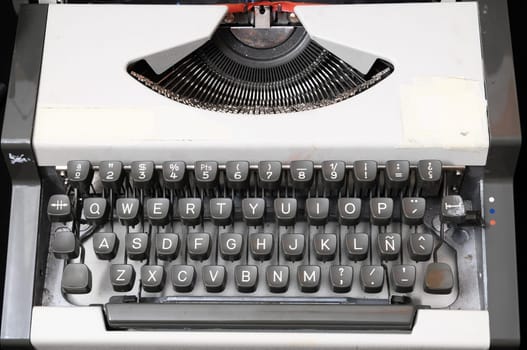 An Old Travel Vintage Typewriter on a Black Background