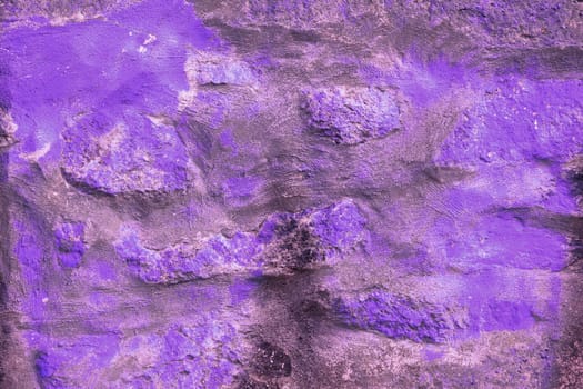 Background: violet wall made of natural stones