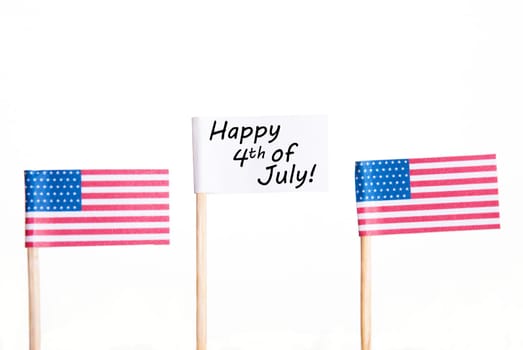 White Banner with Happy 4th of July and two American Flags besides, Isolated