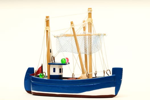 Beautiful miniature ship. Wooden sailship figurine. Antique model sailing boat isolated on white